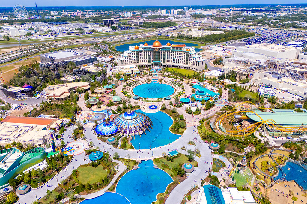 High-angle aerial view of a large resort and theme park complex with pools, rollercoasters, and buildings in Orlando is one of the most popular holiday destinations.