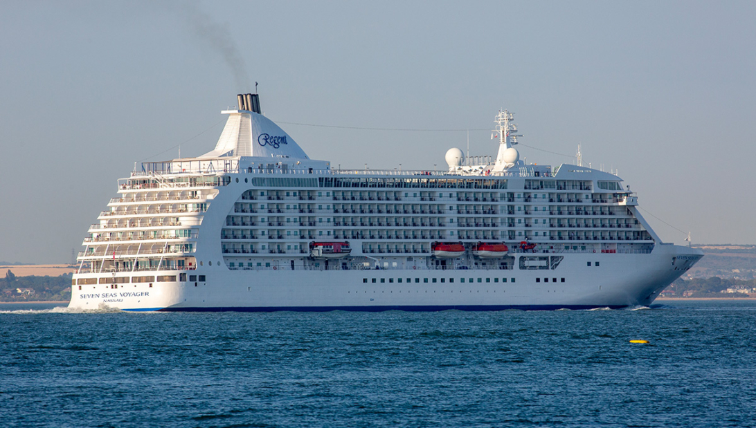 A luxury Regent Seven Seas Voyager cruise ship sailing on blue ocean waters, representing options available when booking the best cruise lines from Southampton.