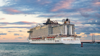 A large cruise ship sailing on the ocean during a colorful sunset, illustrating the best time to book a cruise for scenic ocean voyages.