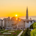 A panoramic sunset view of a lush green park in Brussels City Center, offering a scenic perspective for travelers deciding where to stay in Brussels.