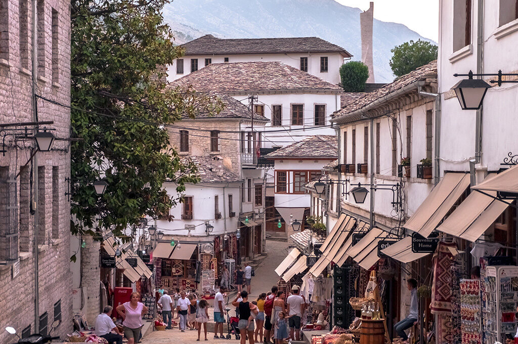 Historic stone-paved streets and traditional slate-roofed architecture in the UNESCO-listed old town of Gjirokaster, a cultural landmark close to the best places to stay in Albania.