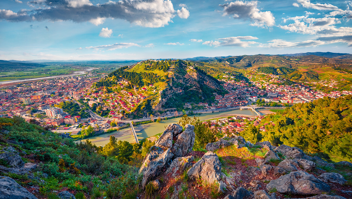 Panoramic view of Berat, Albania, showcasing its historic white Ottoman houses layered on a hillside, perfect for travelers researching the best places to stay in Albania.