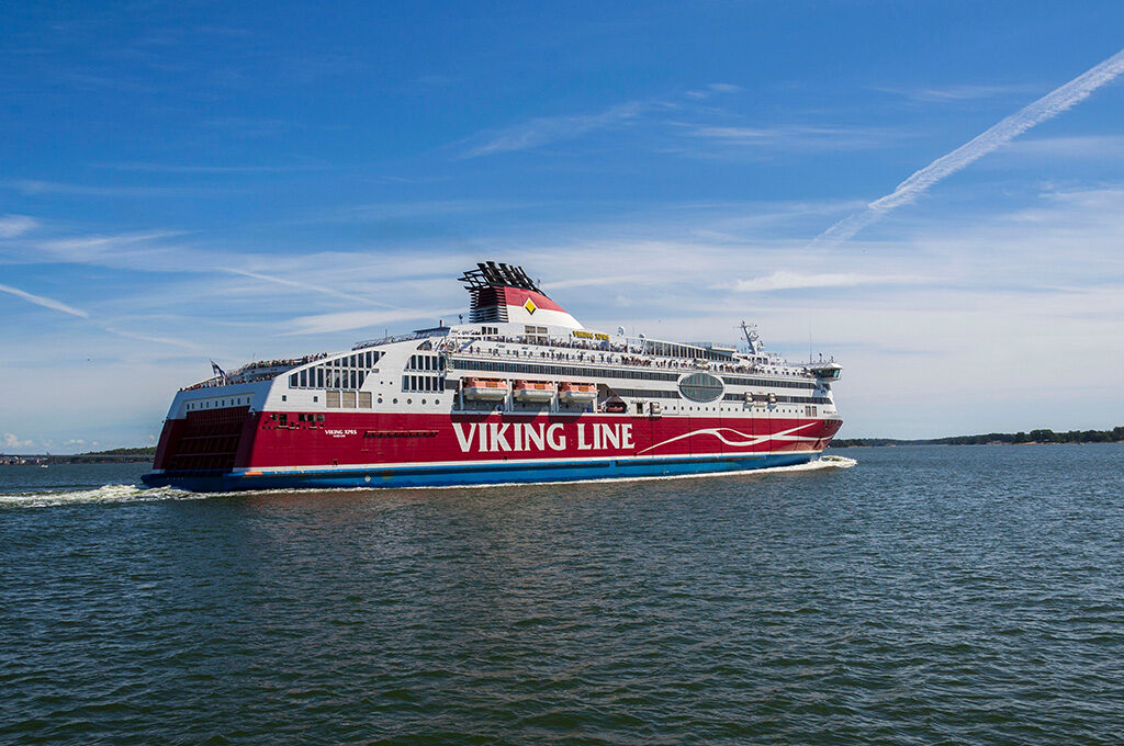 A Viking Line passenger ferry cruising across open water under a bright blue sky, a popular alternative for travelers looking into the best cruise lines from Southampton.