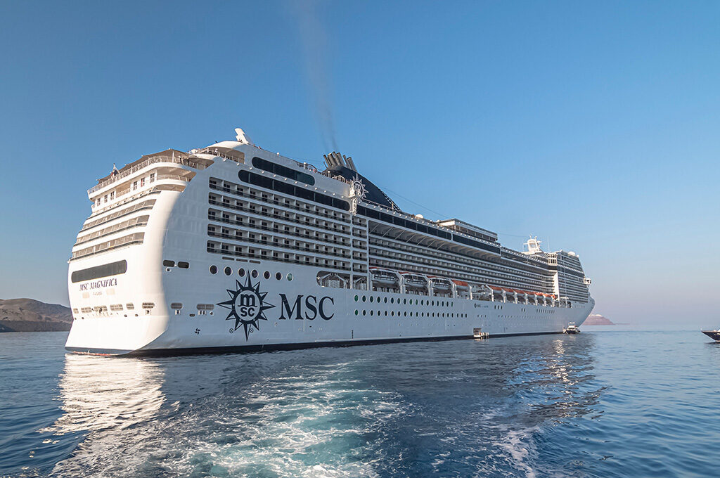 An MSC cruise ship sailing across deep blue sea leaving a white wake, capturing a popular option for the best cruise lines from Southampton.