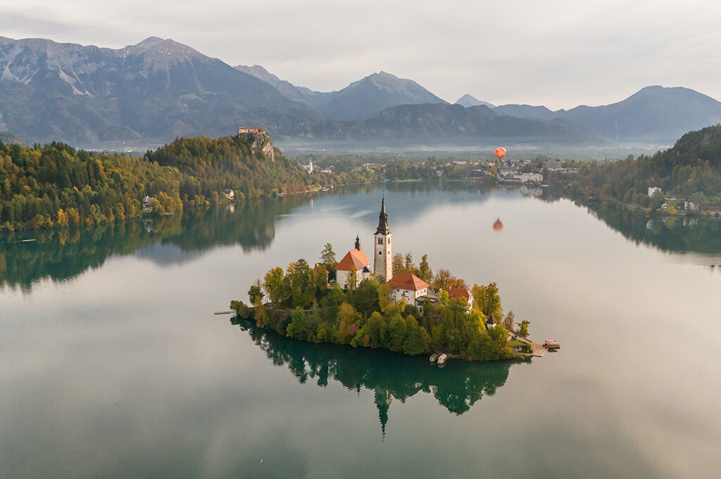 Scenic aerial view of Lake Bled island and church, one of the best Eastern European cities to visit in Slovenia.