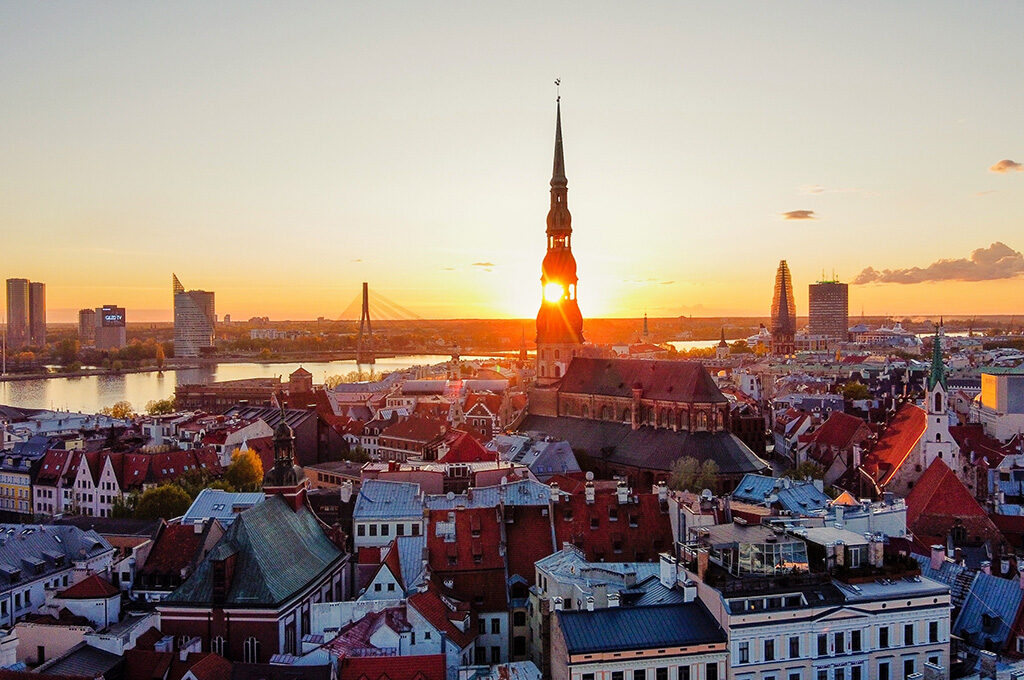 Sunset over the historic spire of St. Peter's Church in Riga, one of the best Eastern European cities to visit.