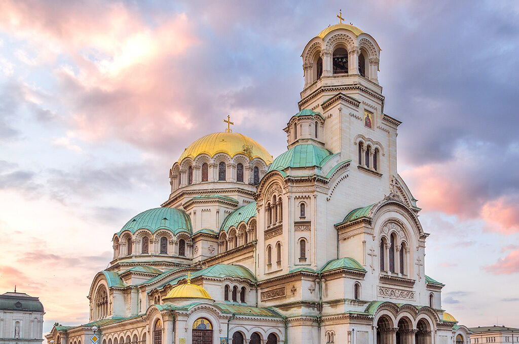 St. Alexander Nevsky Cathedral with golden domes against a sunset sky in Sofia, one of the best Eastern European cities to visit.