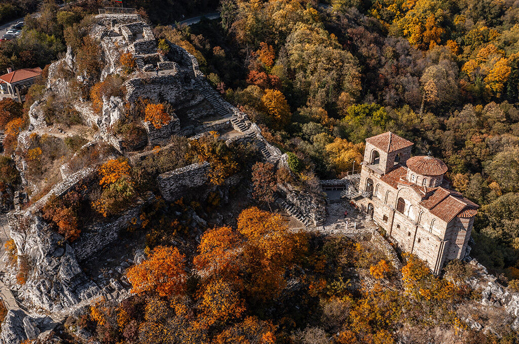 Historic medieval fortress and church on a rocky hill in Bulgaria, highlighted as a top attraction near the best Eastern European cities to visit.