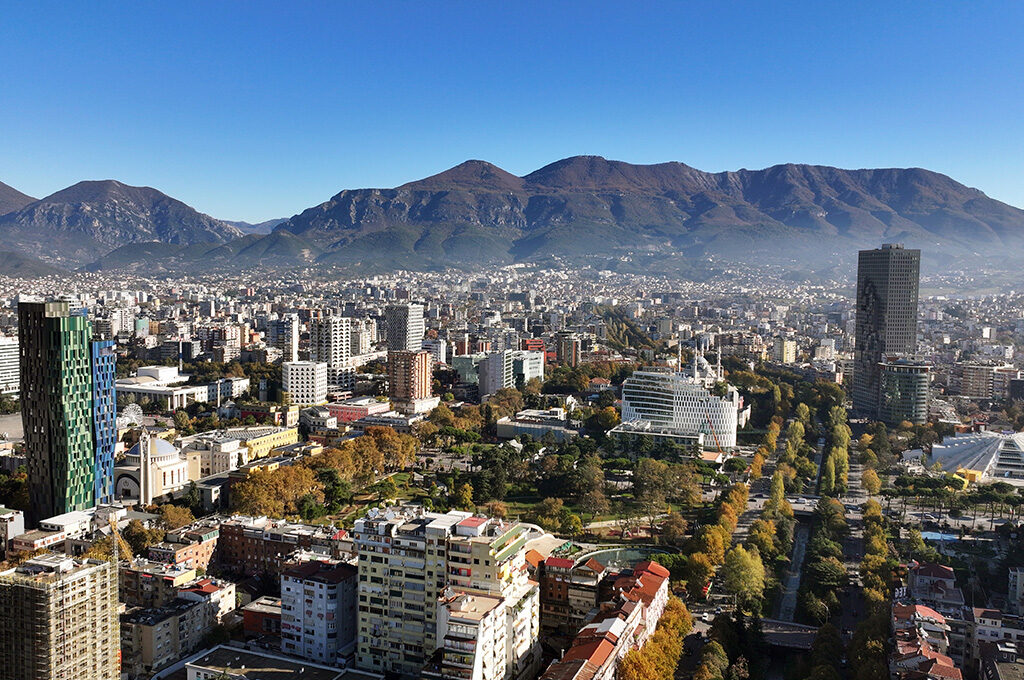 Aerial skyline view of Tirana with Mount Dajti in the background, recognized as one of the best Eastern European cities to visit.