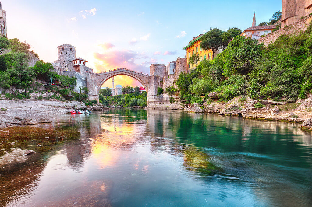 Historic Stari Most (Old Bridge) reflected in the Neretva River in Mostar, one of the best Eastern European cities to visit.