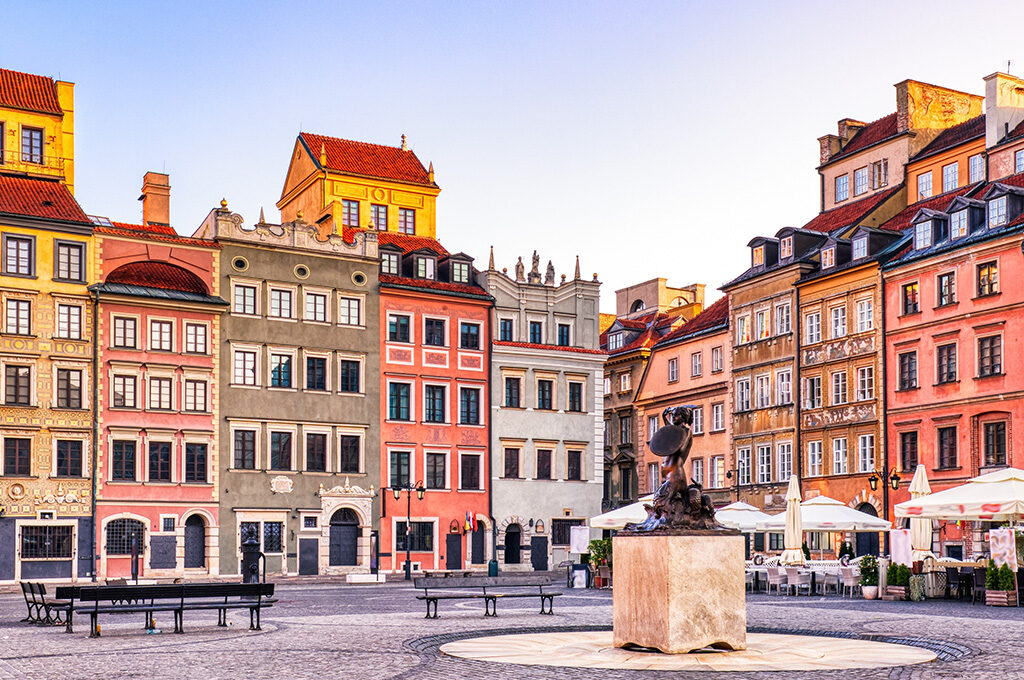 Warsaw Mermaid Statue surrounded by vibrant pastel buildings in Poland, featured among the best Eastern European cities to visit.