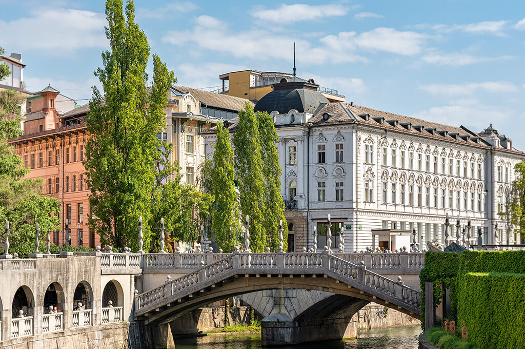 Stone bridge crossing the Ljubljanica River in Ljubljana, one of the best Eastern European cities to visit.