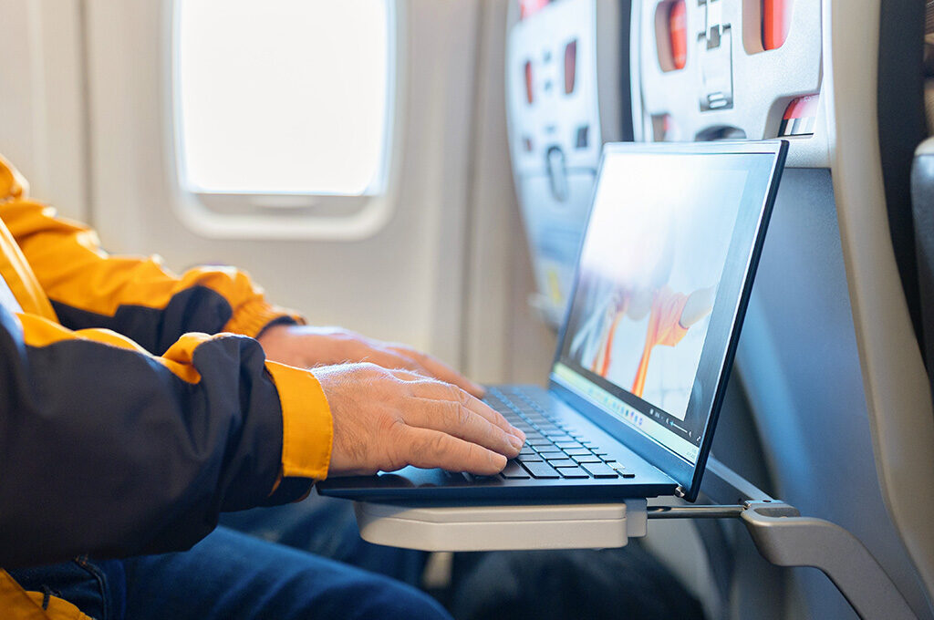 Passenger using laptop airplane economy,Best Economy Airlines - VGUK Blog